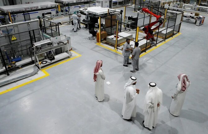 Workers are seen at the solar plant factory in Uyayna, north of Riyadh